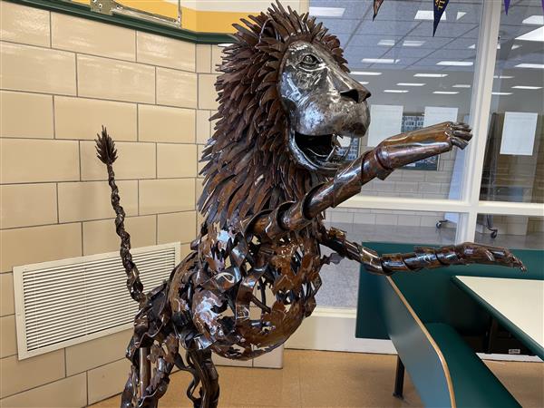 A full length view of the lion sculpture.